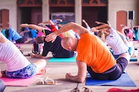 yoga class with multiple people stretching