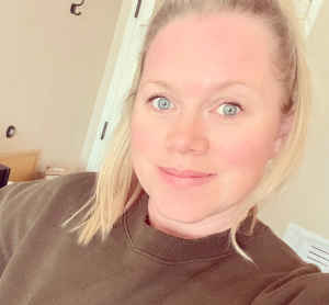 Provider Crystal Dudley's headshot indoors wearing a brown top